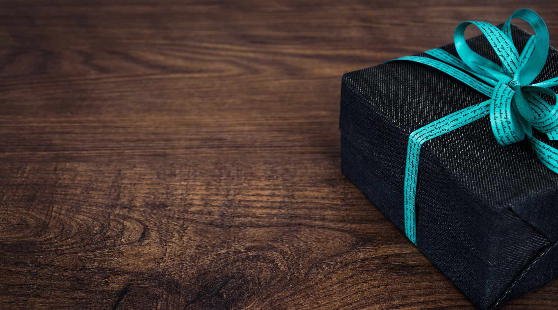 Pictured is a gift package resting on a table